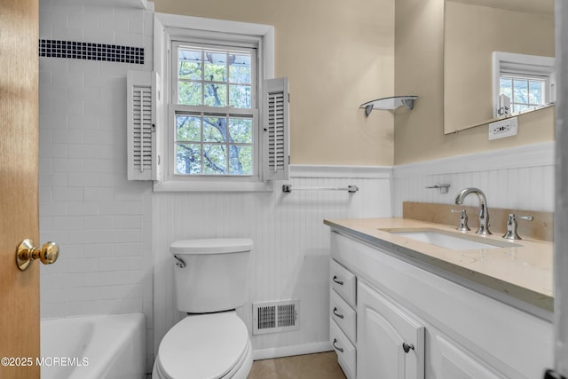 132 Tunes Brook Dr, Brick, NJ 08723 - full bathroom with healthy amount of natural light, toilet, wainscoting, vanity, and tile patterned flooring