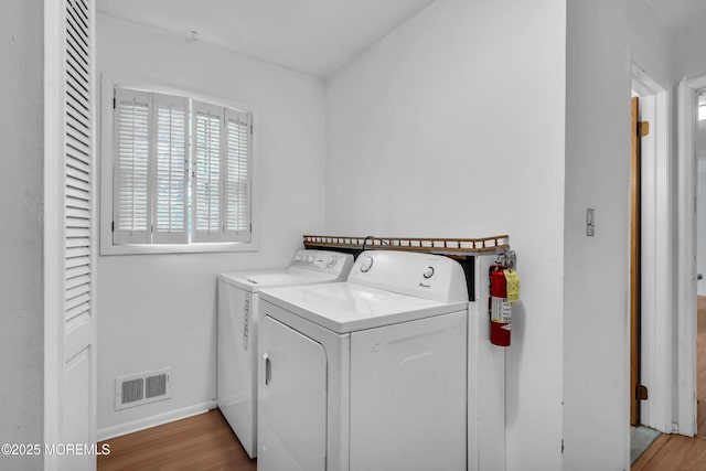 132 Tunes Brook Dr, Brick, NJ 08723 - clothes washing area featuring separate washer and dryer, wood finished floors, and baseboards