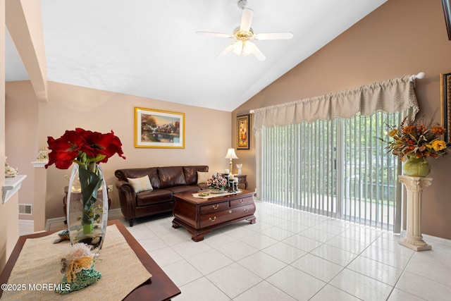living area with vaulted ceiling, ceiling fan, light tile patterned flooring, and baseboards