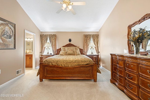 bedroom with light colored carpet, lofted ceiling, ensuite bathroom, baseboards, and ceiling fan