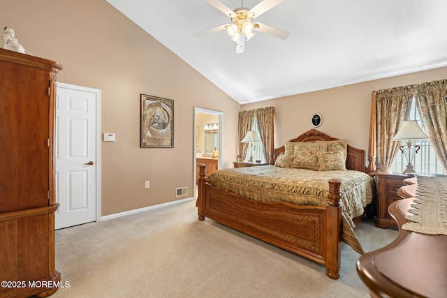 bedroom with light carpet, multiple windows, high vaulted ceiling, baseboards, and ensuite bathroom