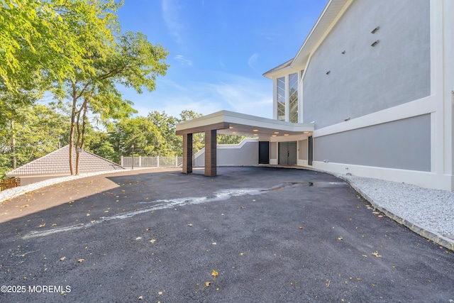 401 Overlook Dr, Neptune Township, NJ 07753 - view of parking with fence, a carport, and asphalt driveway