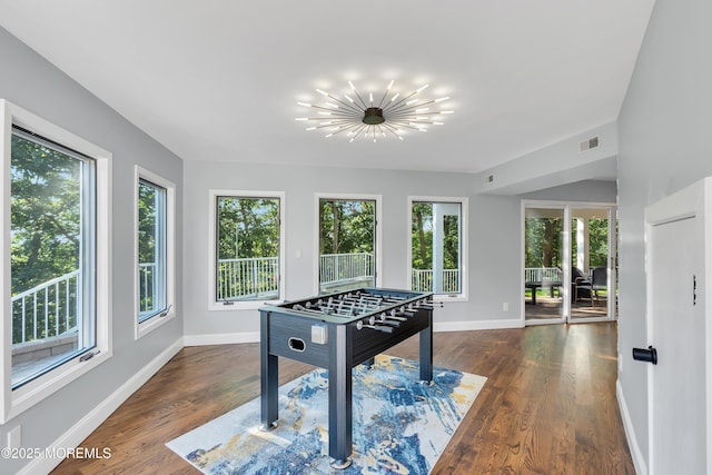 401 Overlook Dr, Neptune Township, NJ 07753 - rec room featuring healthy amount of natural light, baseboards, wood finished floors, and a chandelier