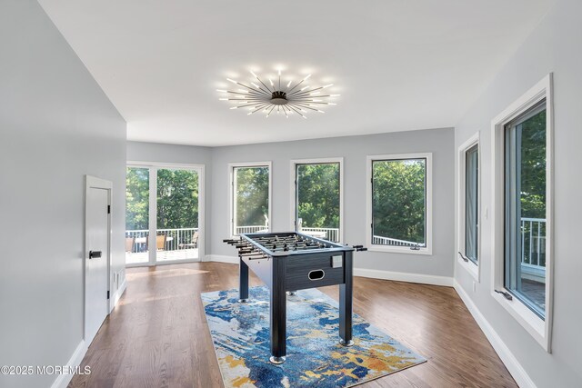 401 Overlook Dr, Neptune Township, NJ 07753 - game room with baseboards, wood finished floors, and a chandelier