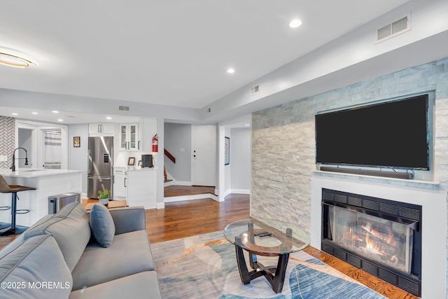 401 Overlook Dr, Neptune Township, NJ 07753 - living area with stairway, a fireplace, wood finished floors, and baseboards