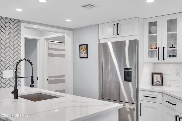 401 Overlook Dr, Neptune Township, NJ 07753 - kitchen featuring stainless steel fridge, a sink, light stone countertops, glass insert cabinets, and white cabinetry