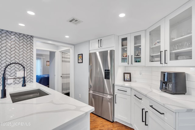 401 Overlook Dr, Neptune Township, NJ 07753 - kitchen featuring stainless steel fridge, a sink, recessed lighting, glass insert cabinets, and light stone counters