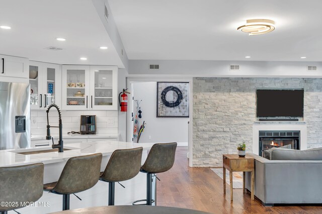 401 Overlook Dr, Neptune Township, NJ 07753 - kitchen with a sink, stainless steel fridge, light stone countertops, a kitchen bar, and recessed lighting