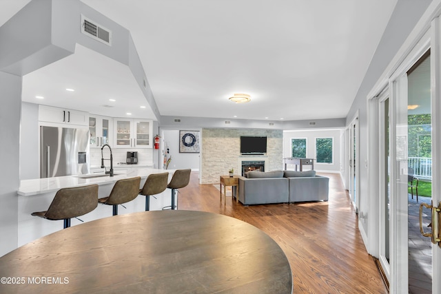 401 Overlook Dr, Neptune Township, NJ 07753 - dining room featuring wood finished floors, a stone fireplace, and recessed lighting