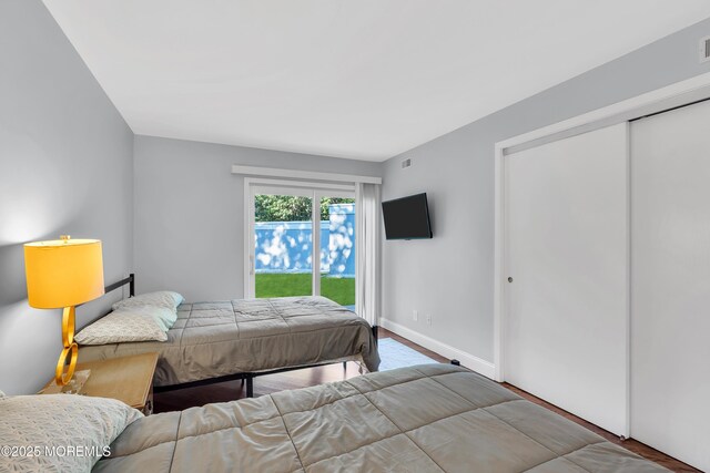 401 Overlook Dr, Neptune Township, NJ 07753 - bedroom featuring access to exterior, baseboards, and wood finished floors