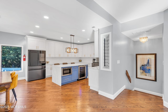401 Overlook Dr, Neptune Township, NJ 07753 - kitchen with stainless steel appliances, beverage cooler, a chandelier, light countertops, and recessed lighting