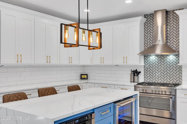 401 Overlook Dr, Neptune Township, NJ 07753 - kitchen featuring stainless steel range, wall chimney range hood, beverage cooler, white cabinetry, and tasteful backsplash