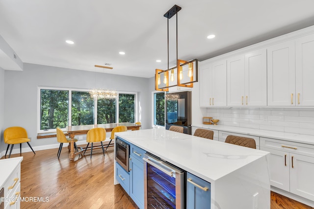 401 Overlook Dr, Neptune Township, NJ 07753 - kitchen featuring beverage cooler, white cabinetry, recessed lighting, blue cabinets, and stainless steel microwave