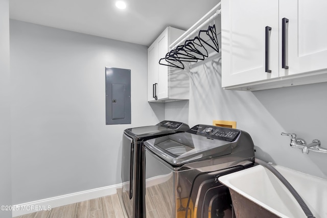 401 Overlook Dr, Neptune Township, NJ 07753 - clothes washing area featuring electric panel, cabinet space, washing machine and dryer, wood finished floors, and baseboards