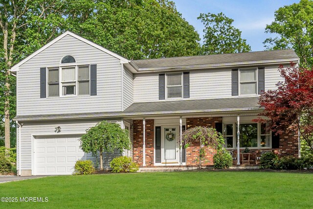 6 Blanche Dr, New Egypt, NJ 08533 - view of front of home featuring an attached garage, a porch, a front lawn, and brick siding