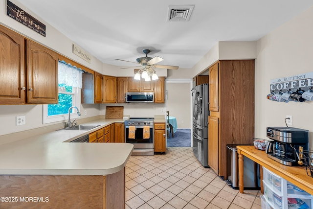 6 Blanche Dr, New Egypt, NJ 08533 - kitchen with stainless steel appliances, a sink, light countertops, ceiling fan, and a peninsula