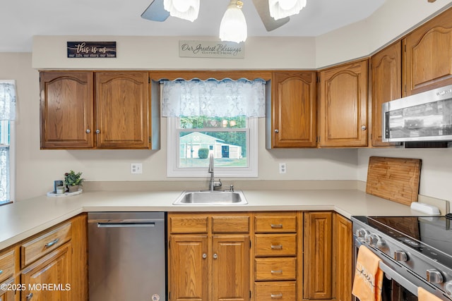 6 Blanche Dr, New Egypt, NJ 08533 - kitchen with appliances with stainless steel finishes, a sink, brown cabinetry, ceiling fan, and light countertops