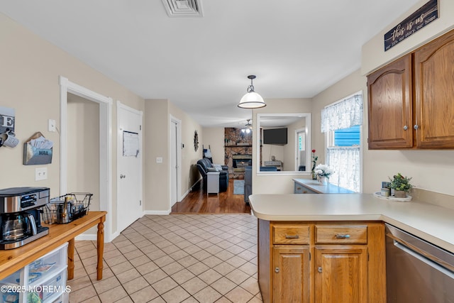 6 Blanche Dr, New Egypt, NJ 08533 - kitchen featuring dishwasher, light countertops, a fireplace, a peninsula, and light tile patterned flooring
