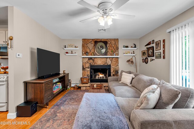 6 Blanche Dr, New Egypt, NJ 08533 - living room with a ceiling fan, light wood-type flooring, and a stone fireplace