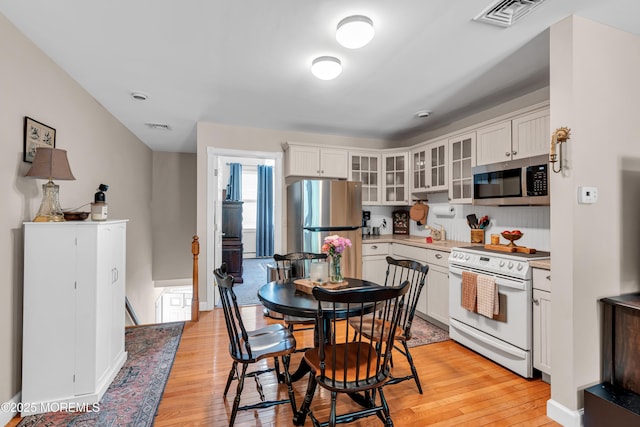 6 Blanche Dr, New Egypt, NJ 08533 - kitchen with stainless steel appliances, light wood-style flooring, and white cabinets