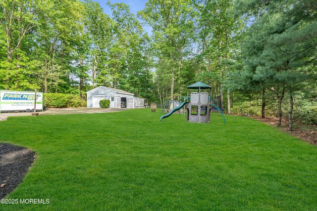 6 Blanche Dr, New Egypt, NJ 08533 - view of grassy yard featuring a playground, a garage, and an outdoor structure