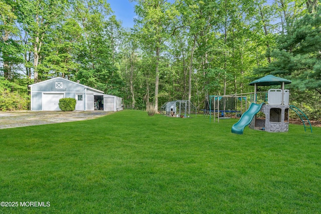 6 Blanche Dr, New Egypt, NJ 08533 - view of green lawn with a playground, a garage, an outbuilding, and driveway