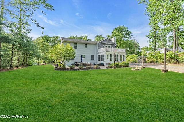 6 Blanche Dr, New Egypt, NJ 08533 - back of house featuring a balcony, a yard, a patio area, and a chimney