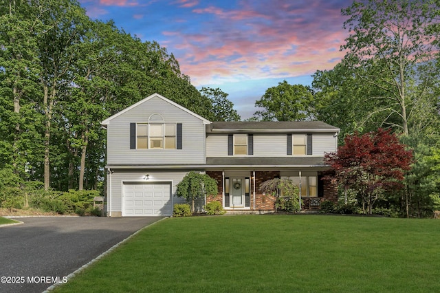 6 Blanche Dr, New Egypt, NJ 08533 - view of front of house with asphalt driveway, a lawn, an attached garage, and a porch