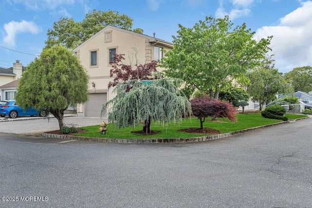251 Genes Dr, Toms River, NJ 08753 - view of front of house with an attached garage, stucco siding, and driveway