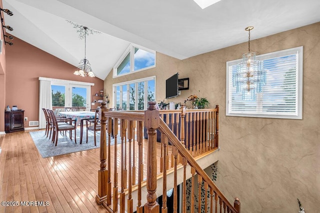 251 Genes Dr, Toms River, NJ 08753 - stairs with a chandelier, hardwood / wood-style flooring, lofted ceiling, and baseboards