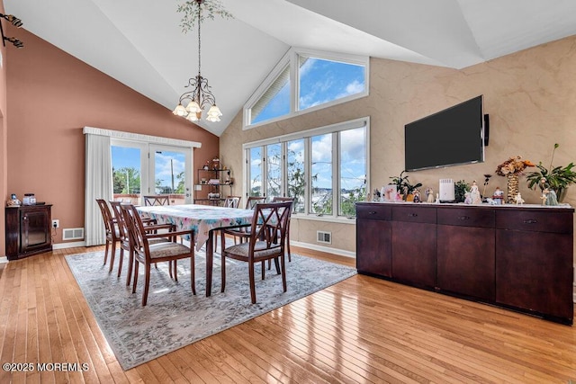251 Genes Dr, Toms River, NJ 08753 - dining space featuring light wood-style flooring, a chandelier, high vaulted ceiling, and baseboards