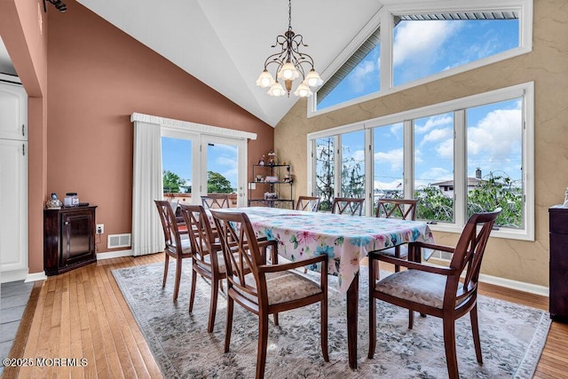 251 Genes Dr, Toms River, NJ 08753 - dining room featuring a chandelier, light wood-type flooring, high vaulted ceiling, and baseboards
