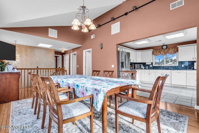 251 Genes Dr, Toms River, NJ 08753 - dining space with a chandelier, light wood finished floors, and high vaulted ceiling