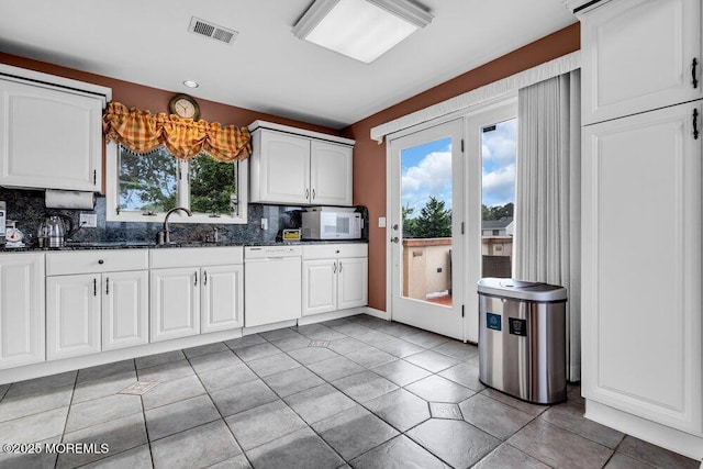 251 Genes Dr, Toms River, NJ 08753 - kitchen featuring white appliances, backsplash, light tile patterned floors, dark stone countertops, and white cabinets