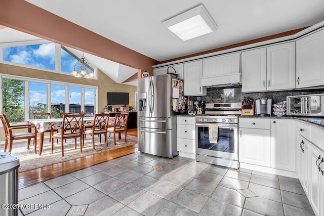 251 Genes Dr, Toms River, NJ 08753 - kitchen featuring appliances with stainless steel finishes, dark countertops, a chandelier, backsplash, and vaulted ceiling