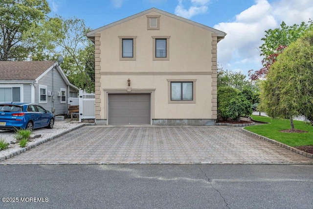 251 Genes Dr, Toms River, NJ 08753 - view of side of property featuring decorative driveway, a garage, and stucco siding