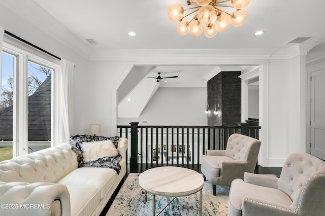 living room featuring a chandelier, ceiling fan, recessed lighting, wood finished floors, and crown molding