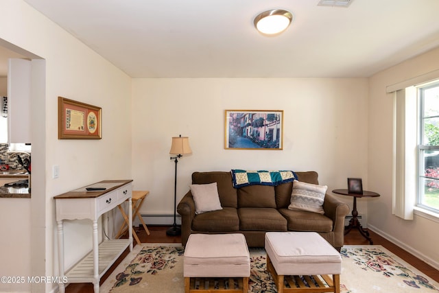 102 Clear Lake Rd, Whiting, NJ 08759 - living area with a baseboard heating unit, wood finished floors, and healthy amount of natural light