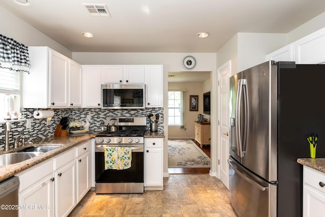 102 Clear Lake Rd, Whiting, NJ 08759 - kitchen with appliances with stainless steel finishes, white cabinets, a sink, backsplash, and recessed lighting