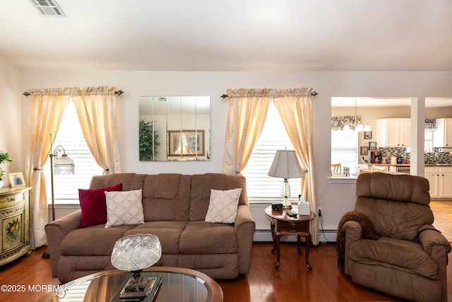 102 Clear Lake Rd, Whiting, NJ 08759 - living area featuring wood finished floors, baseboard heating, a chandelier, and a baseboard radiator