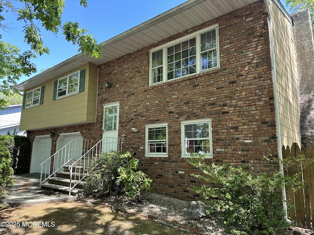 697 Vaughn Ave, Toms River, NJ 08753 - view of front facade with a garage and brick siding