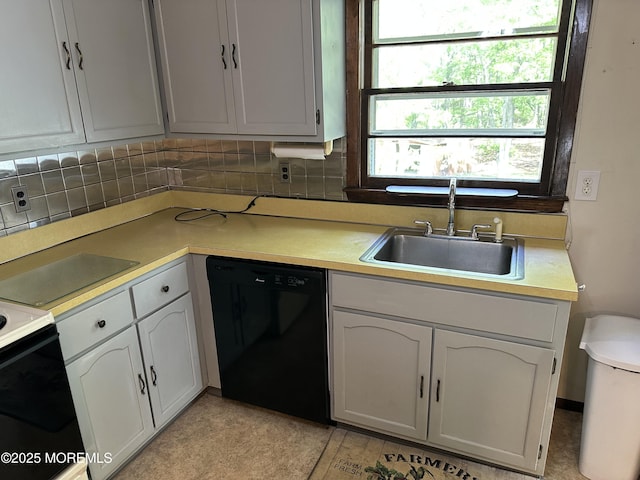 697 Vaughn Ave, Toms River, NJ 08753 - kitchen featuring black dishwasher, a sink, tasteful backsplash, light countertops, and electric range