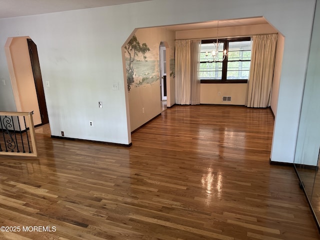 697 Vaughn Ave, Toms River, NJ 08753 - spare room with a chandelier, wood finished floors, and baseboards
