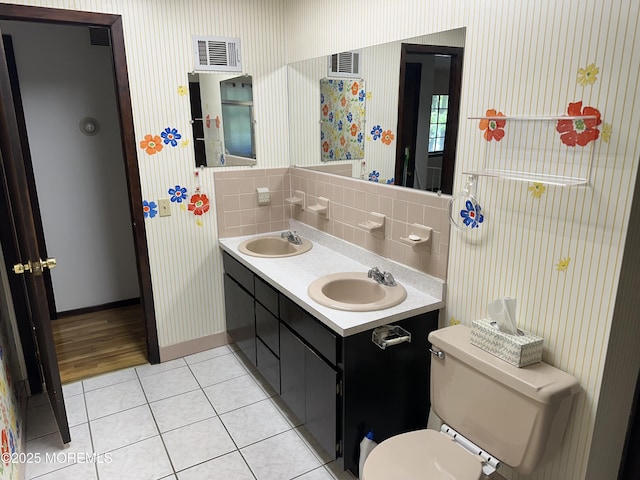 697 Vaughn Ave, Toms River, NJ 08753 - full bathroom featuring tile patterned flooring, toilet, decorative backsplash, double vanity, and baseboards