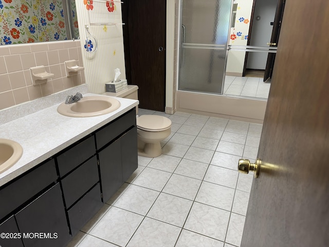 697 Vaughn Ave, Toms River, NJ 08753 - full bath with wallpapered walls, toilet, tile patterned flooring, bath / shower combo with glass door, and double vanity