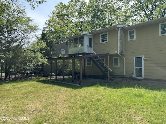 697 Vaughn Ave, Toms River, NJ 08753 - back of house with a sunroom, a patio area, a lawn, and stairway