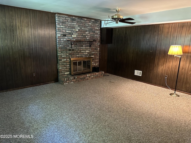 697 Vaughn Ave, Toms River, NJ 08753 - unfurnished living room featuring ceiling fan, wood walls, a fireplace, and carpet