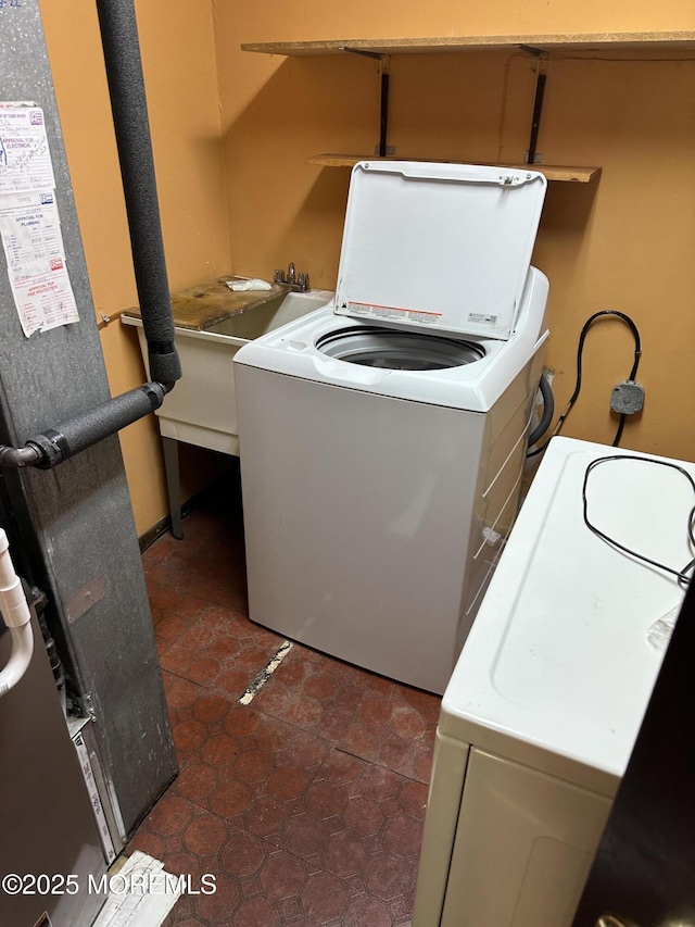 697 Vaughn Ave, Toms River, NJ 08753 - laundry area with washer / dryer, heating unit, a sink, and dark tile patterned floors