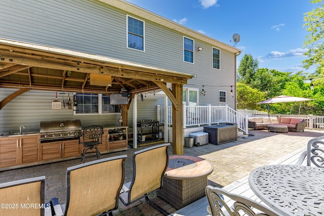 view of patio / terrace featuring area for grilling, an outdoor hangout area, a gazebo, and a sink