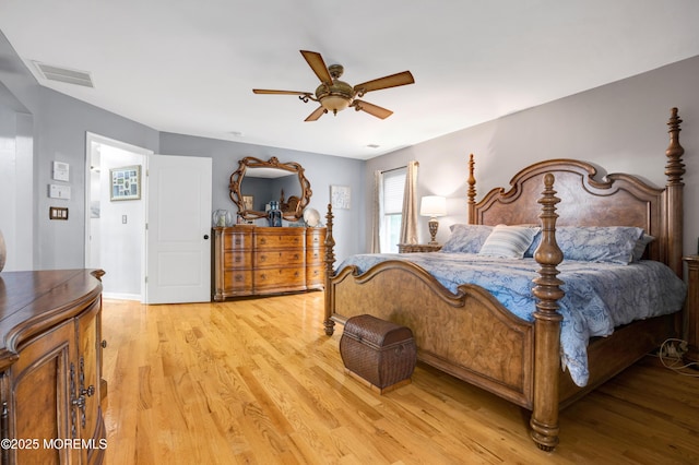 bedroom featuring light wood finished floors, a ceiling fan, and baseboards